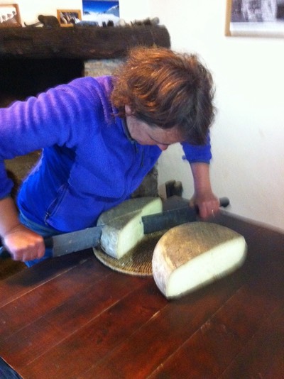 Sandrine cutting cheese wheel